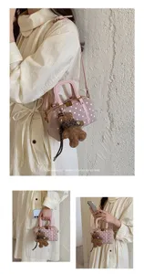 Pink polka dot Boston bag with cute bear charm, stylish shoulder crossbody bag for women.