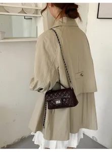 Detail view of dark brown quilted chain shoulder bag, classic design with turn lock.