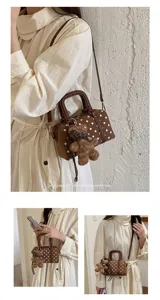 Women polka dot boston shoulder bag with cute bear pendant for daily stylish commute.