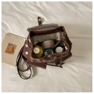 Detailed view of the Korean style polka dot backpack showing internal striped lining and structure.