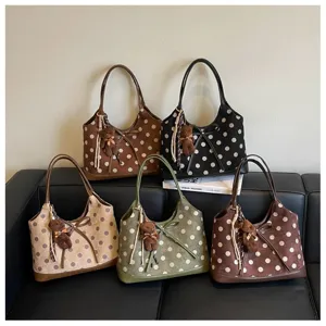 Stylish polka dot underarm shoulder bag for women with cute bear pendant and large capacity.