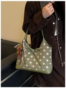 Green polka dot shoulder bag for women, stylish underarm tote with bow and cute bear charm.