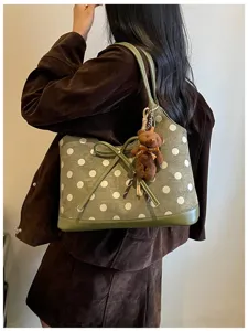 Korean style polka dot shoulder underarm bag detail showing green suede fabric and bear pendant.