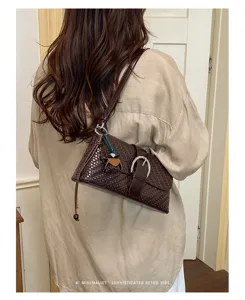 French vintage brown woven underarm bag for women, chic shoulder baguette bag with buckle.