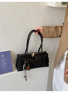 Black woven leather boston shoulder bag detail, stylish pillow handbag with dual handles.