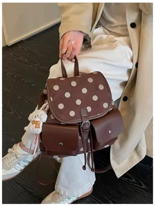 Korean style brown polka dot backpack with front pockets and cute pendant for daily commute.