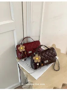 Chic quilted chain shoulder bag with cute straw flower charm for women autumn fashion.