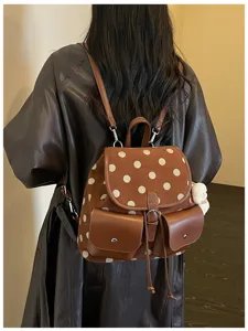 Stylish brown polka dot backpack with dual front pockets and shoulder straps for daily commute.