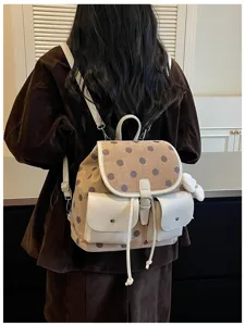 Korean style polka dot backpack for women, casual daily commuter school bag with dual pockets.