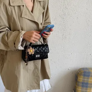 Black quilted chain shoulder bag for women, stylish small crossbody bag with charm.