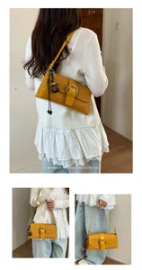 Stylish yellow woven underarm bag for women, retro baguette shoulder bag with metal buckle.