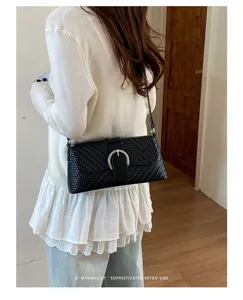 Chic black woven underarm bag for women, retro shoulder baguette bag with stylish metal buckle.