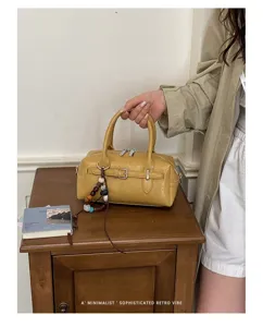 Chic retro yellow Boston handbag with stylish bead charm, versatile daily shoulder bag for women.