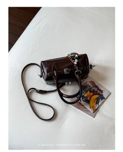Detailed shot of dark brown Boston shoulder bag with chic beaded strap and retro styling.