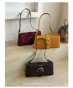 Detailed view of woven leather shoulder bags in burgundy, yellow, and brown with metallic buckles.