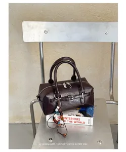 Dark brown Boston handbag, minimalist retro pillow bag with chic bead pendant for daily commuting.