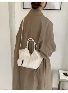 Woven leather tote bag detail view, showing elegant craftsmanship and large daily capacity.