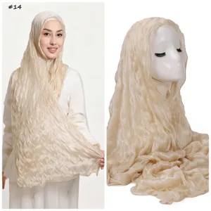 Detailed view of the glossy crushed tulle headscarf, soft breathable lettuce edge design.