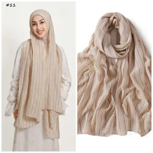 Detailed view of the beige striped sequin scarf showcasing fabric texture and drape effect.