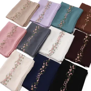 Detailed view of women lightweight floral embroidered long scarf with bow design, versatile accessory.