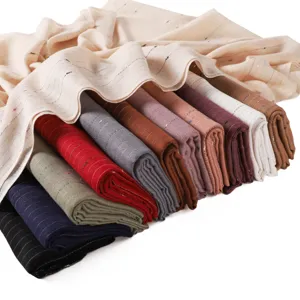 Detailed view of lightweight striped metallic silk scarves, showing multiple color options close up.