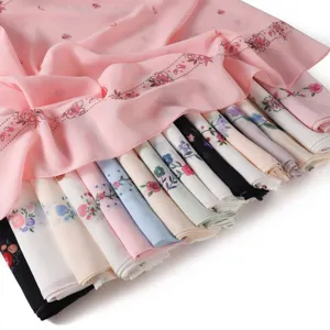 Detail view of floral print chiffon scarf, lightweight fabric with vibrant spring designs.