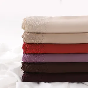 Detailed view of lightweight chiffon hijab with elegant camellia embroidery in assorted colors.