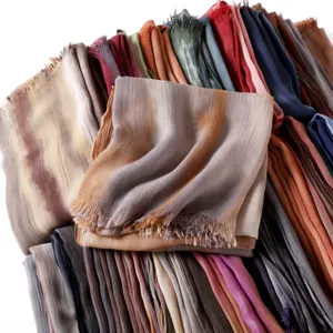 Gradient crinkle scarf detail showing soft breathable fabric and fringed edges in various colors.