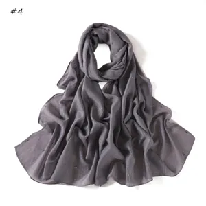 Detailed view of the grey lightweight striped scarf featuring subtle colorful glitter threads.