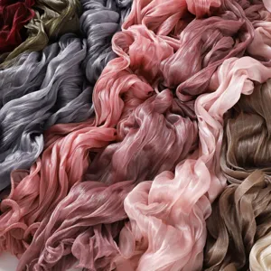 Close-up detail of glossy pleated sheer scarf, soft breathable fabric texture and lettuce edge.