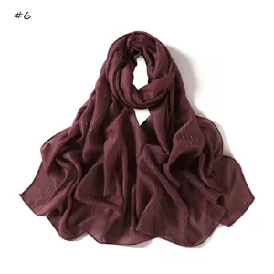 Detailed view of the striped metallic dot long scarf, breathable and stylish fabric.