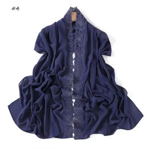Navy blue chiffon scarf detail featuring delicate camellia embroidery and lightweight design.