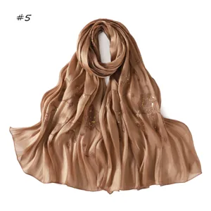 Detailed shot of the brown sequin embroidered satin scarf, showing delicate craftsmanship.
