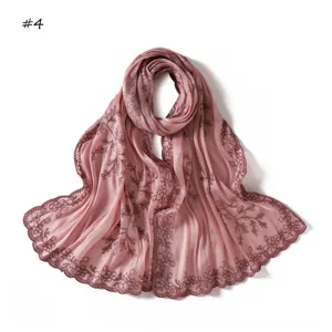 Detailed view of the pink sequin embroidered scarf with delicate lace trim, elegant chic.