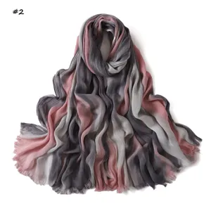 Detailed view of the gradient rayon long scarf showcasing soft wrinkled texture and fine fringe.