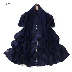 Detailed shot of dark blue chiffon scarf featuring elegant embroidered floral lace trim, lightweight design.
