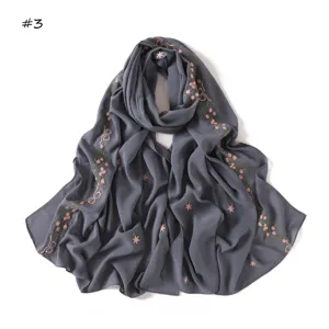 Close-up detail of the elegant grey scarf featuring pink embroidered roses and delicate bows.