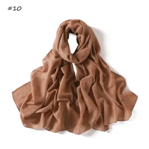 Close-up of lightweight brown striped scarf with colorful dots, breathable women's neck wrap.