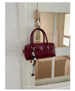 Chic dark red Boston pillow bag with beaded charm, stylish commuter handbag for women.