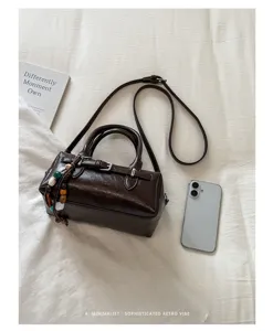 Retro brown Boston shoulder bag with beaded charm and strap, stylish minimalist daily purse.