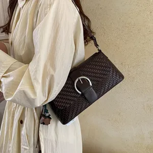 Brown leather woven shoulder bag for women, stylish underarm baguette handbag for autumn.