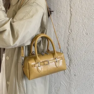 Stylish yellow Boston shoulder bag for women, premium glossy leather crossbody design.