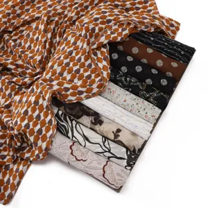 Detailed view of fashionable chiffon scarves featuring diverse floral, dot and abstract prints.