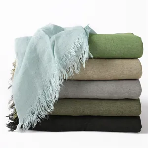 Soft crinkled long scarf with fringes, breathable rayon material in multiple solid colors.