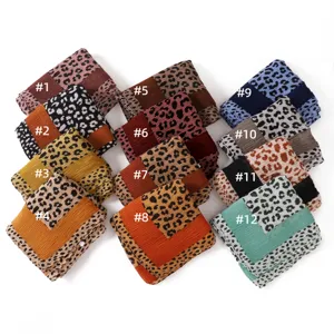 Detailed view of colorful leopard print pleated scarves, soft textured wrap shawl.