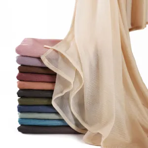 Close-up detail of soft bark-textured pleated long scarf, breathable fabric, multi-color gradient style.