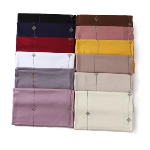 Close-up detail of the four-leaf clover rhinestone line solid color jersey scarf collection.