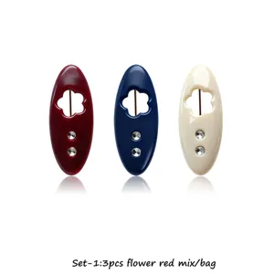 Detailed view of colorful plastic hijab pins with flower cutout and sparkling rhinestones.