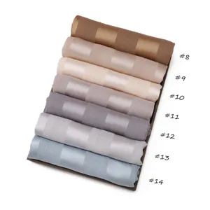 Detailed view of folded silk-feel striped scarves in multiple elegant color options.