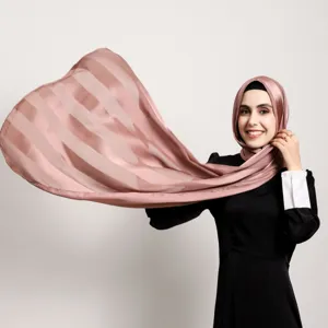 Close-up of dusty pink striped satin hijab, showing smooth fabric texture and soft drape.